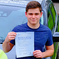 Greg Lynch holding his Driving Test Pass certificate