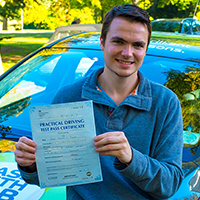 James Phillips holding his Driving Test Pass certificate