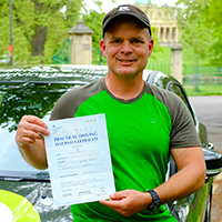 Patrick Murphy holding his Driving Test Pass certificate