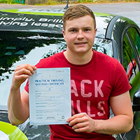 Will Shelley holding his Driving Test Pass certificate